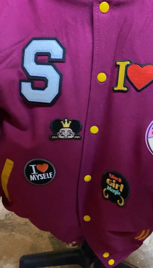 Custom magenta varsity jacket with chenille letter and patches